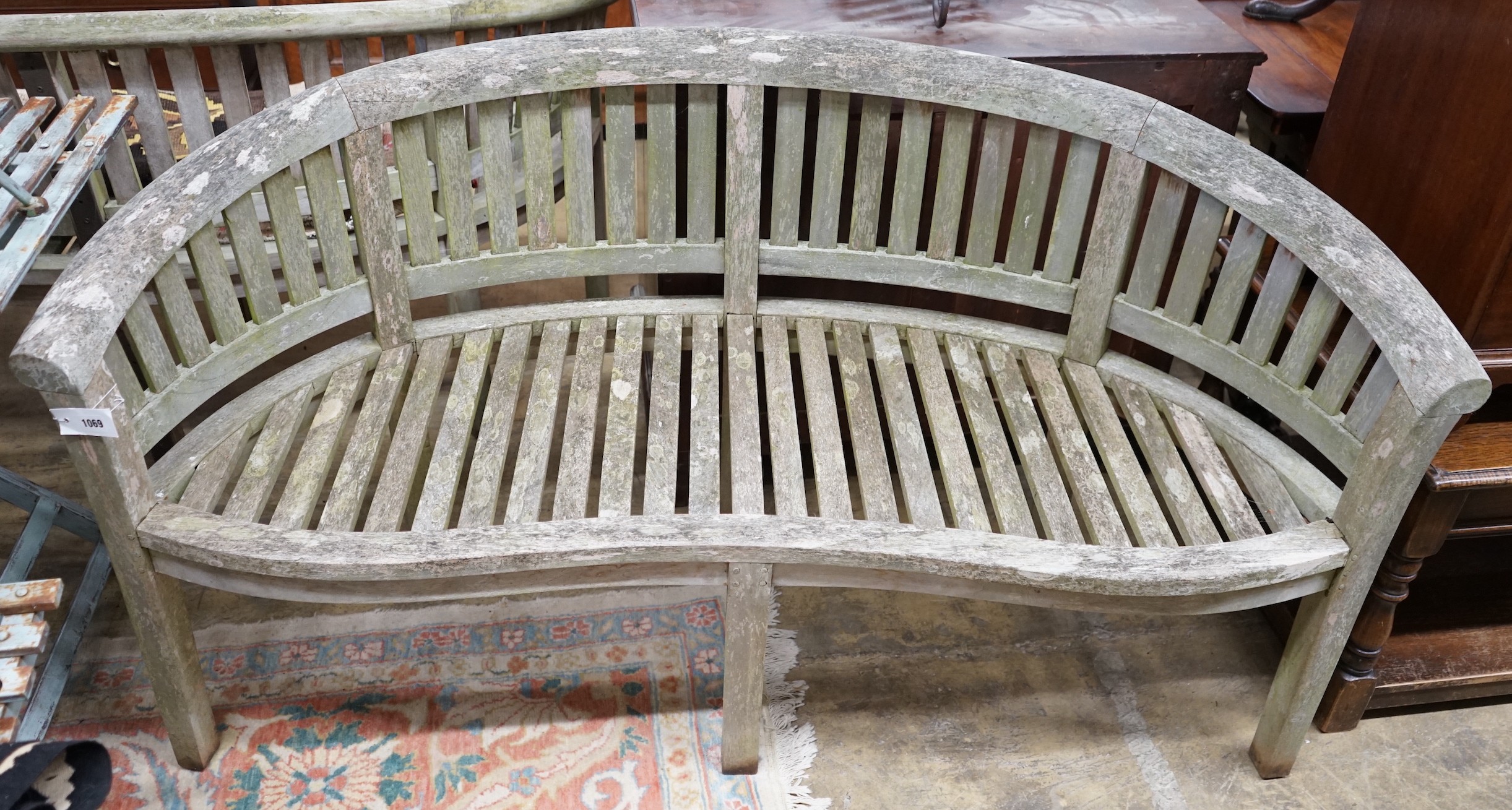 A weathered teak garden banana bench, length 160cm, depth 50cm, height 85cm